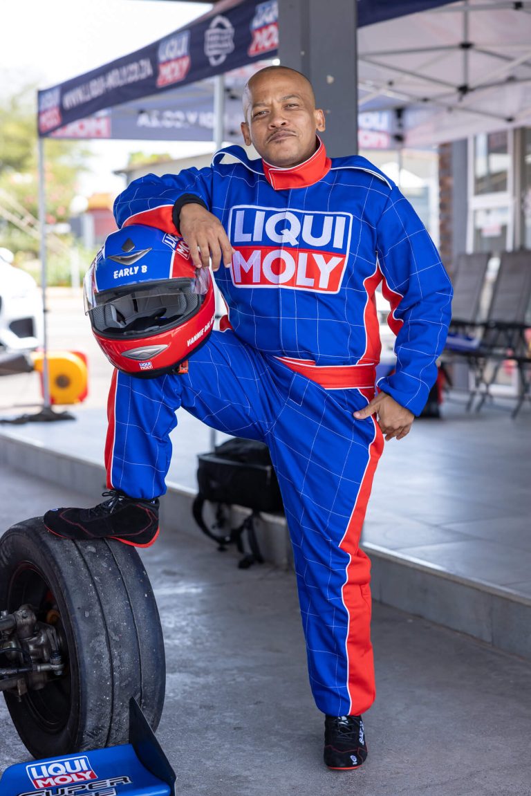 Driver in a Liqui-Moly race suit with a helmet in the pits, photographed by Indirect Media