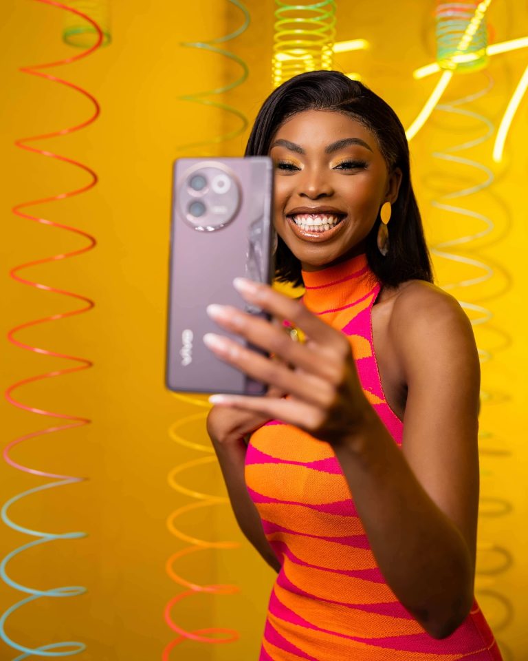 Model taking a selfie with a vivo smartphone on a yellow set, photographed by Indirect Media