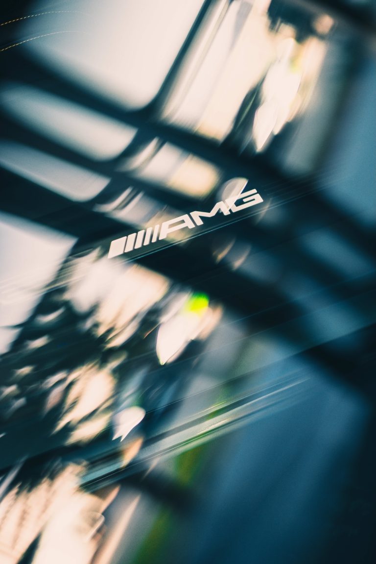 AMG badge through motion-blurred light, photographed by Indirect Media