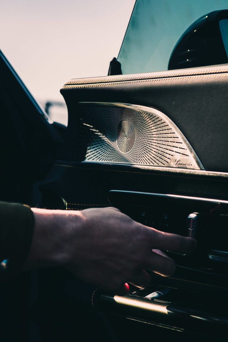 Driver's hand on the console of a Mercedes-AMG, a cinematic interior frame by Indirect Media
