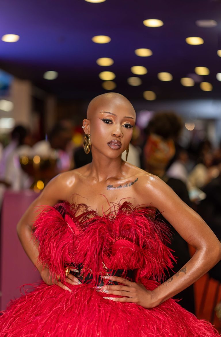 Guest in a red feathered gown at the BNG Awards, photographed by Indirect Media