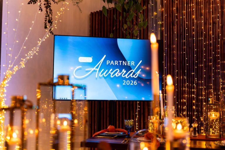 ESET Partner Awards 2026 screen above a candlelit dinner table, photographed by Indirect Media
