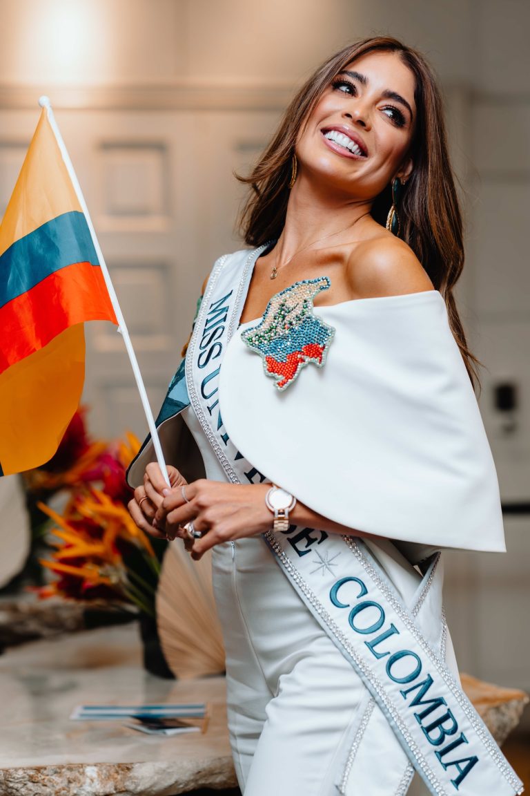 Miss Universe 2023 contestant portrait: Miss Colombia with her flag and sash, photographed by Indirect Media